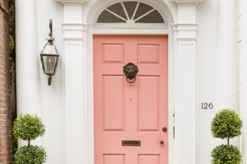 Iconic white house with pink door in Charleston
